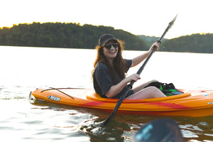 Adventurous millennial kayaking while sporting Noz-up green colored, odorless skunk and bear repellent sunscreen. 